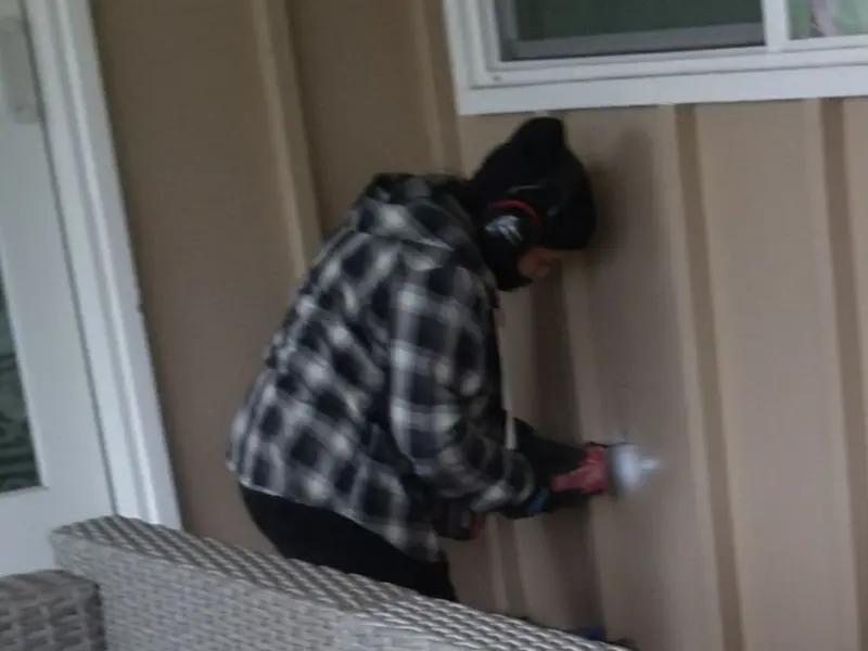 Professional electrician installing an exterior outlet in Turner